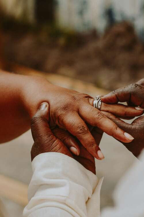 photo of a hand putting a ring on another person's finger